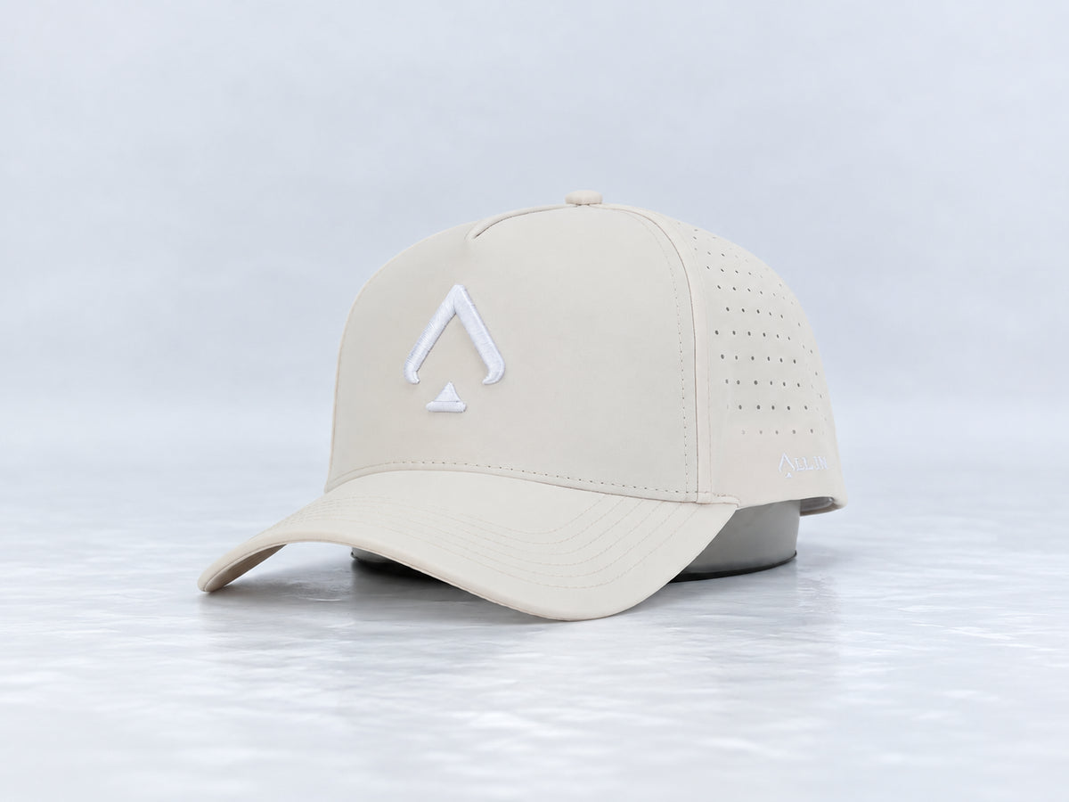 All In Lid Butter hat, three-quarter front view, in cream fabric with a white logo.