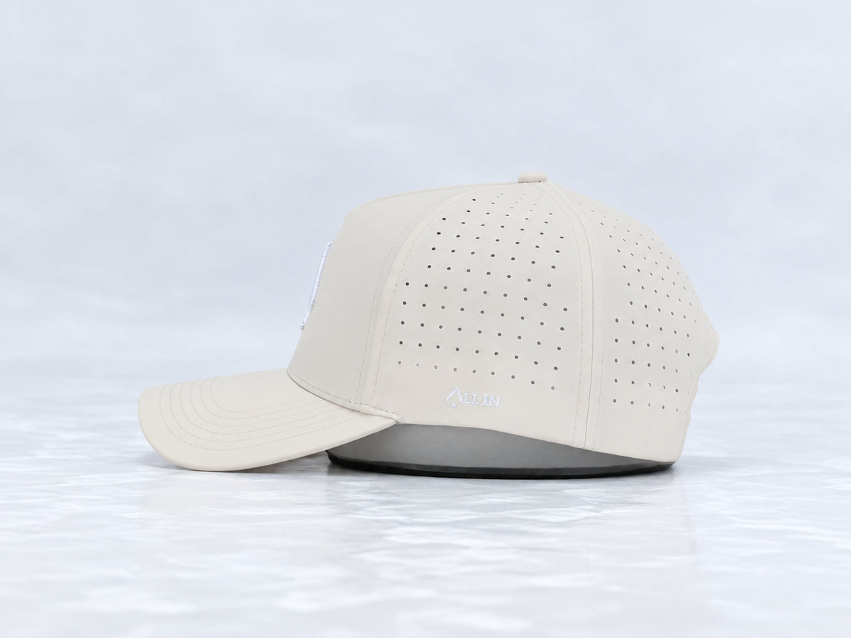 All In Lid Butter hat, side profile, in cream fabric with a white logo.