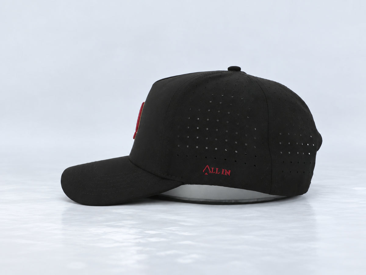 All In Lid Black & Garnet hat, side profile, in black fabric with a gold-edged garnet logo.
