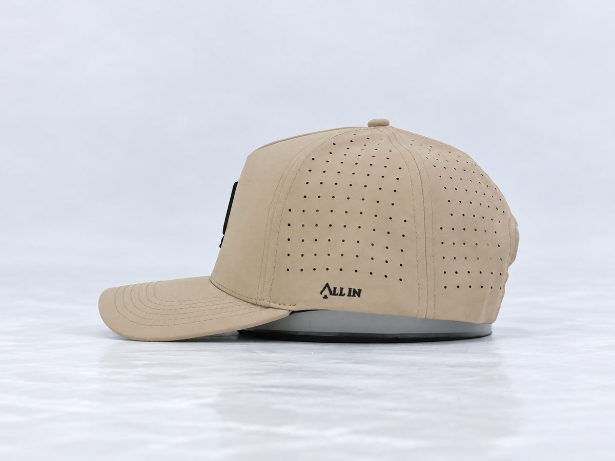 All In Lid Desert Sand hat, side profile, in khaki fabric with a black logo.