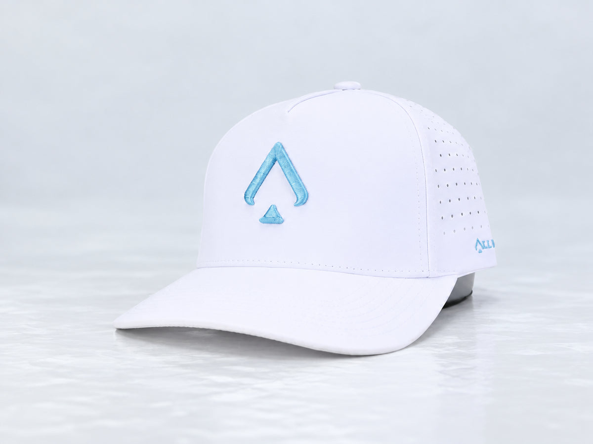 All In Lid Carolina Blue white cap with light blue spade embroidery, front three-quarter view against a pale gray studio background.