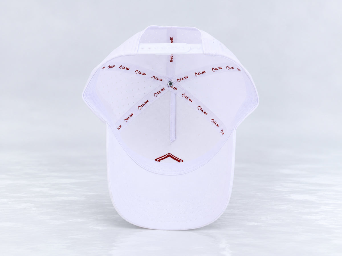 All In Lid Crimson Ice white cap, interior view showing branded seam tape, the sweatband, mesh-backed front panel, and underside of the brim against a pale gray background.