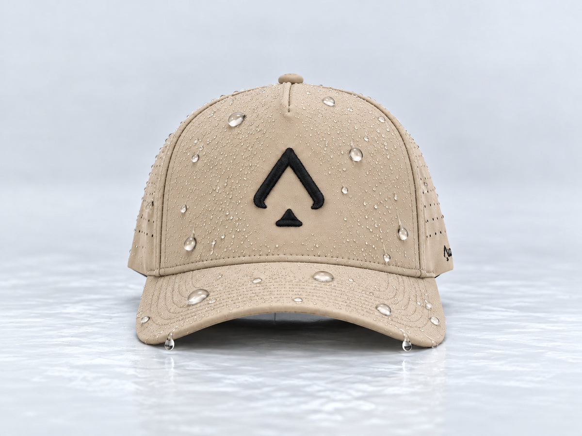Front view of the All In Lid Desert Sand hat with khaki fabric and a black logo and water droplets on the crown and brim.