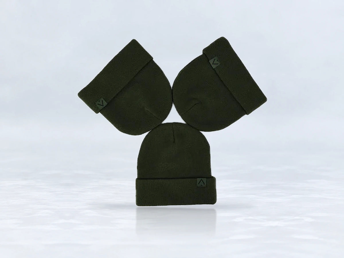 All In Lid Forest Green cuffed beanie in forest green knit with a tonal green logo patch, flat lay of three beanies, against a pale gray studio background.