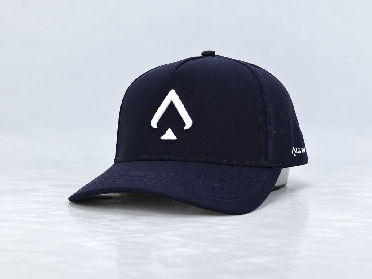 All In Lid Navy Seal navy cap with white spade embroidery, front three-quarter view against a pale gray studio background.