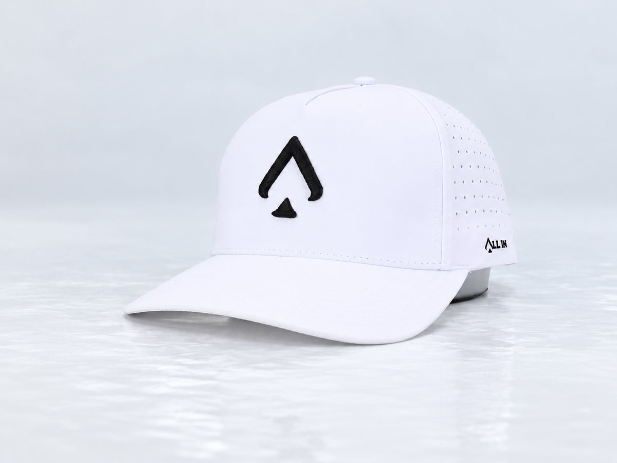 All In Lid OG Reversed white cap with black spade embroidery, front three-quarter view against a pale gray studio background.