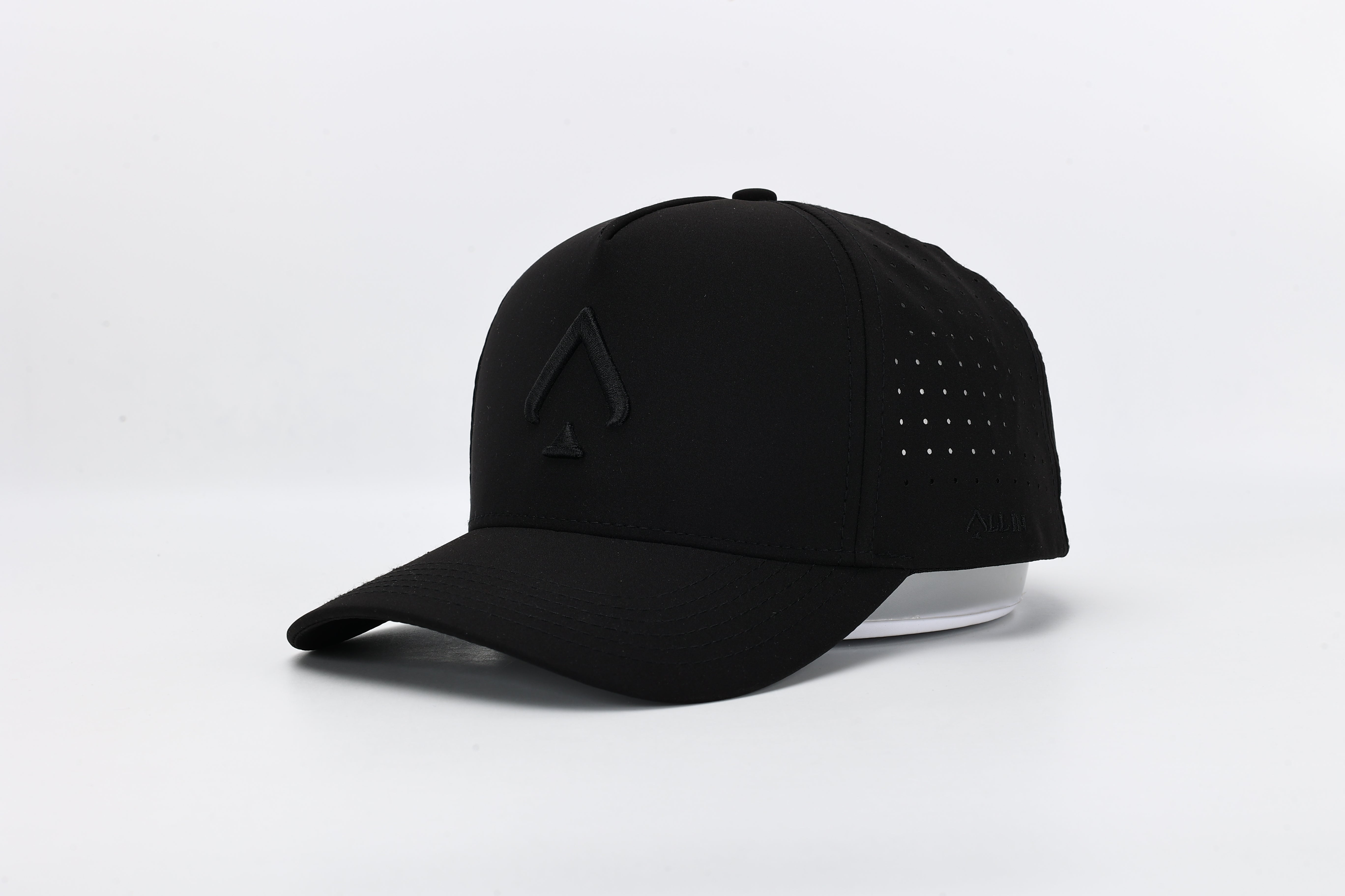 All In Wears Black Out cap in all-black performance fabric with a debossed, matching black spade logo and laser-cut ventilation