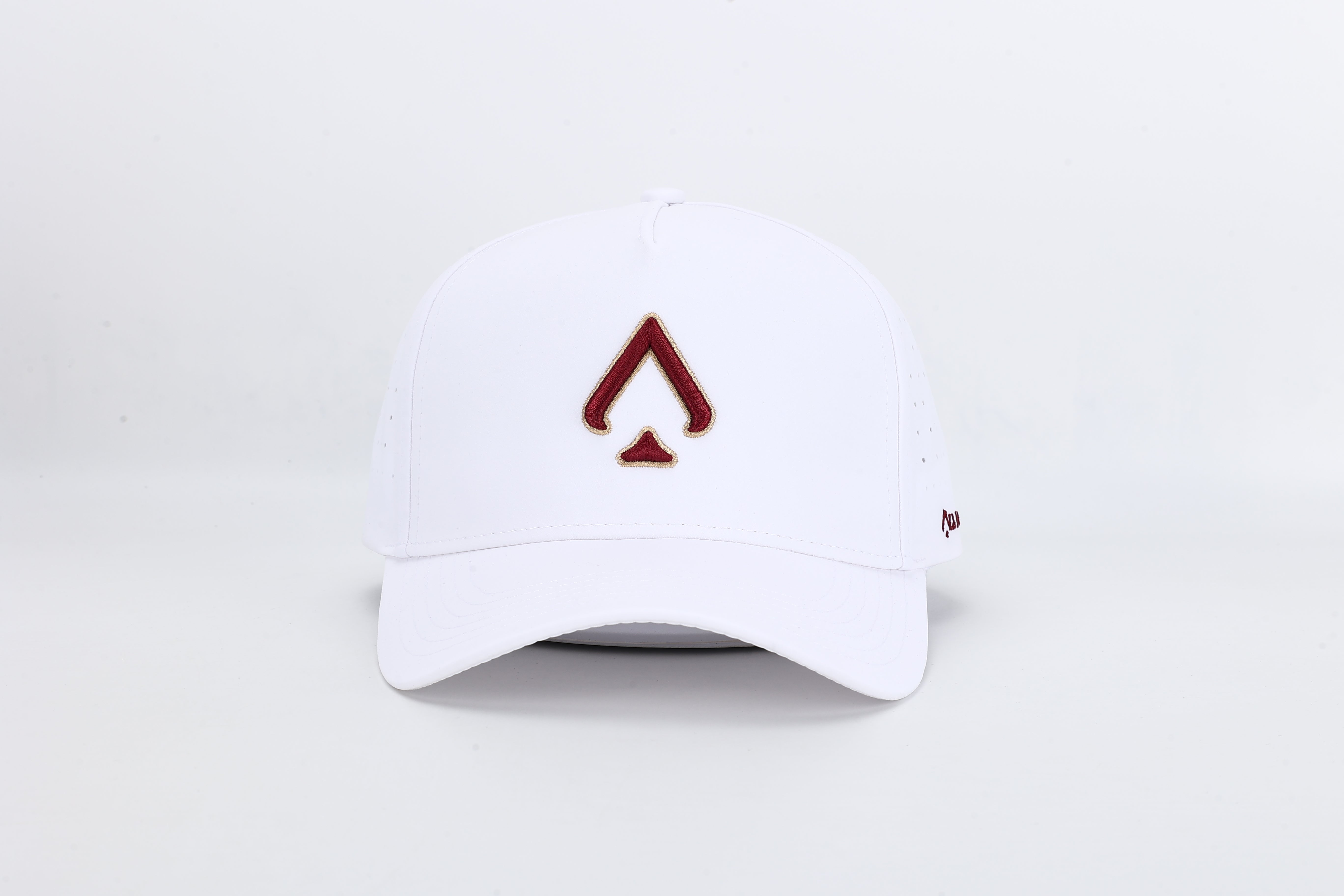 All In Wears Regal White performance cap, featuring a white body and an embroidered garnet and gold outline spade logo.