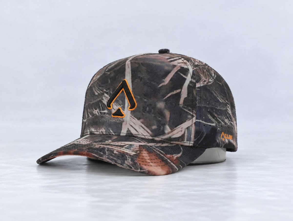 All In Lid Killa Camo hat, three-quarter front view, in woodland camouflage fabric with an orange-outlined black logo.