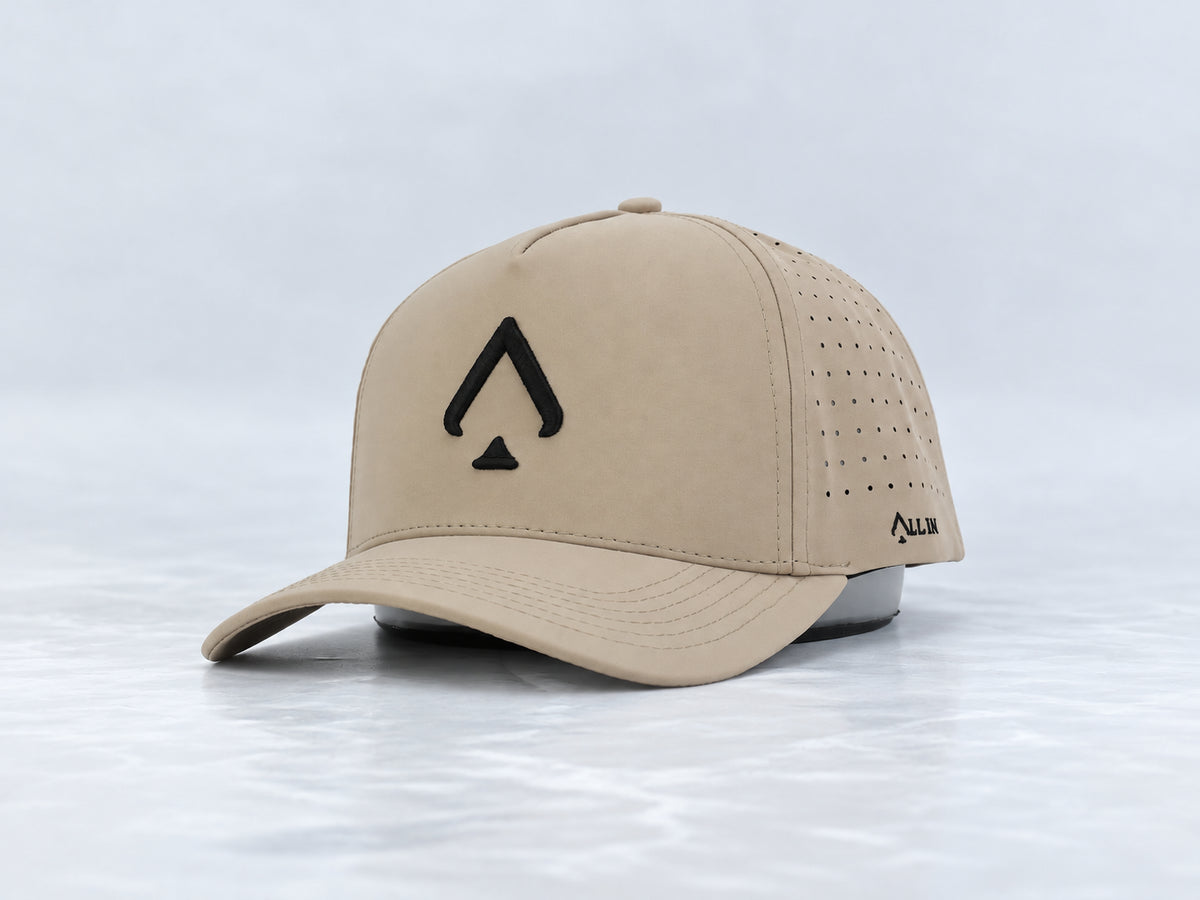 All In Lid Desert Sand hat, three-quarter front view, in khaki fabric with a black logo.