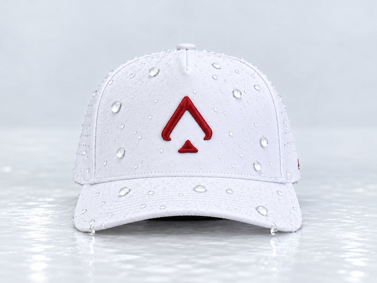 All In Lid Crimson Ice white cap with crimson red spade embroidery and beaded water droplets on the crown and brim, straight-on front view against a pale gray background.