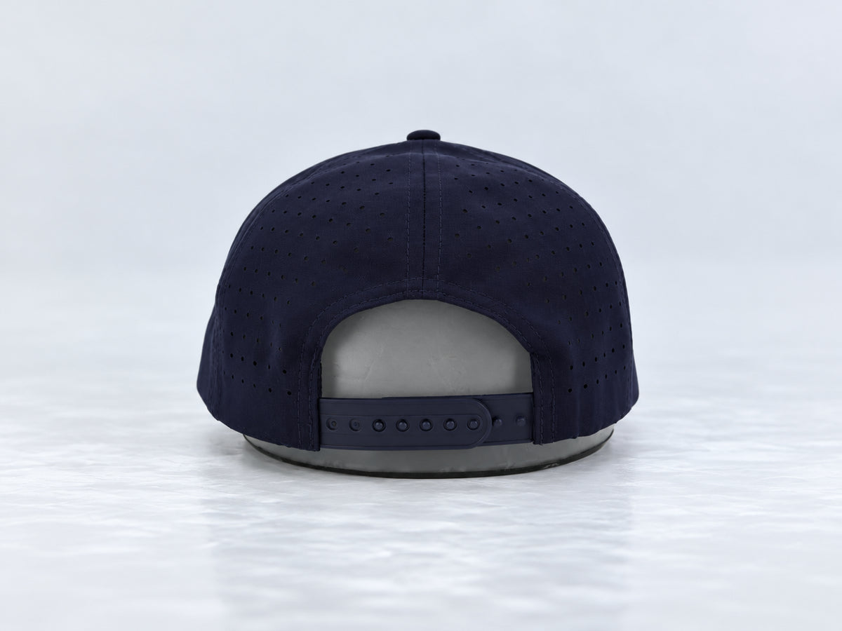 All In Lid Navy Seal navy cap, rear view showing the adjustable snapback closure and perforated panels against a pale gray studio background.