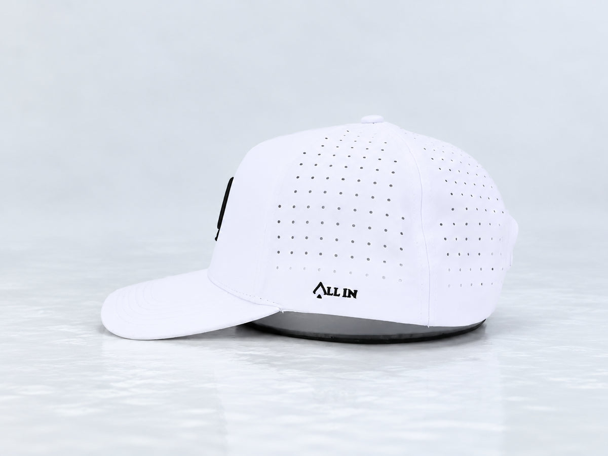 All In Lid OG Reversed white cap, side view with black All In embroidery, perforated panels, and a curved brim against a pale gray background.