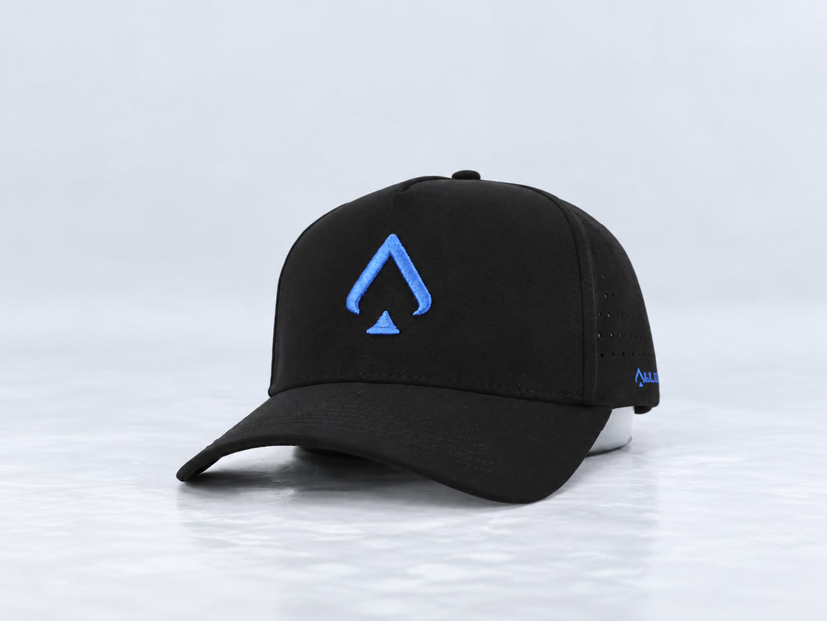 All In Lid Royal Blue black cap with royal blue spade embroidery, front three-quarter view against a pale gray studio background.
