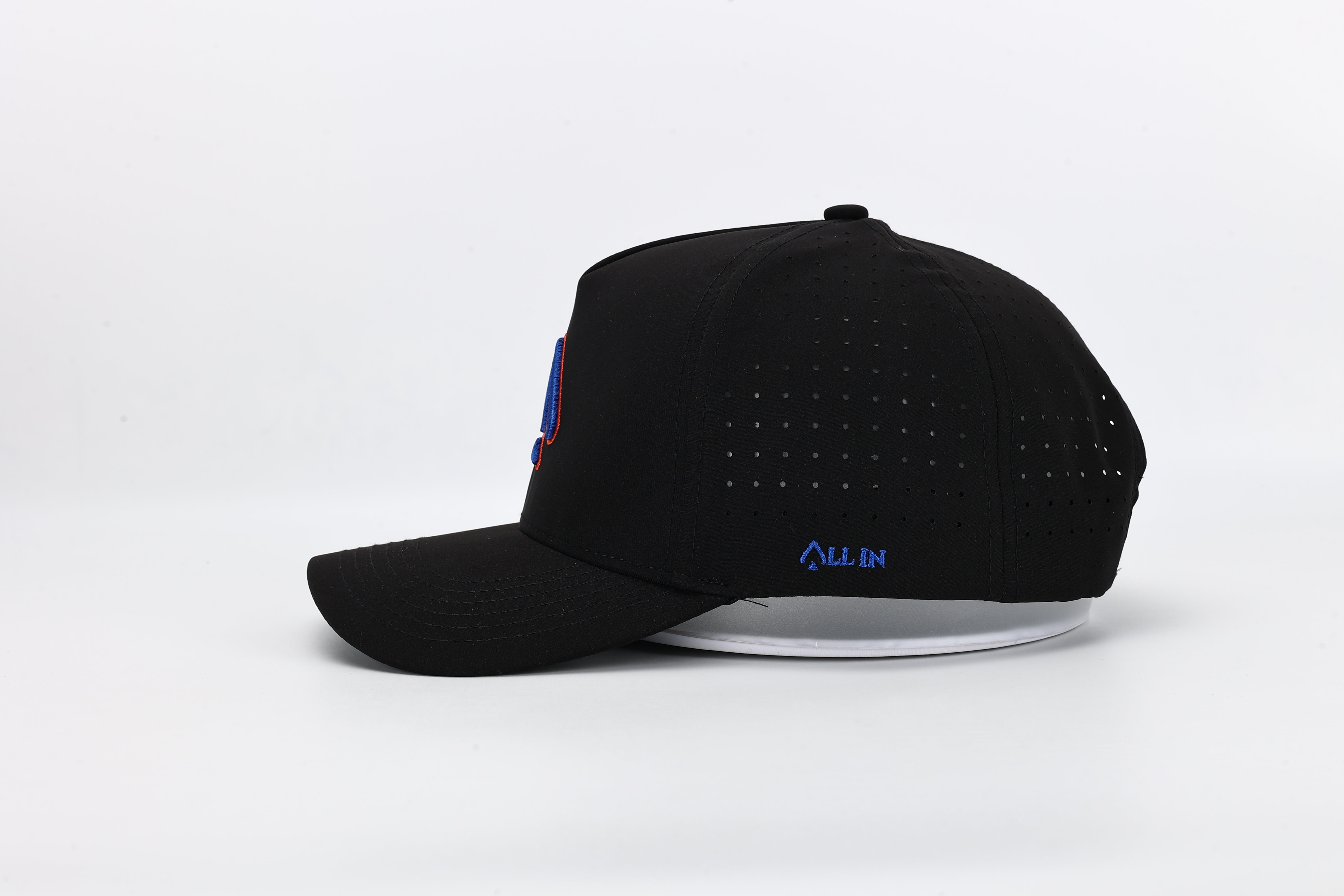 All In Wears Blackout Blaze performance cap, featuring a black body with a striking blue and orange embroidered spade logo.