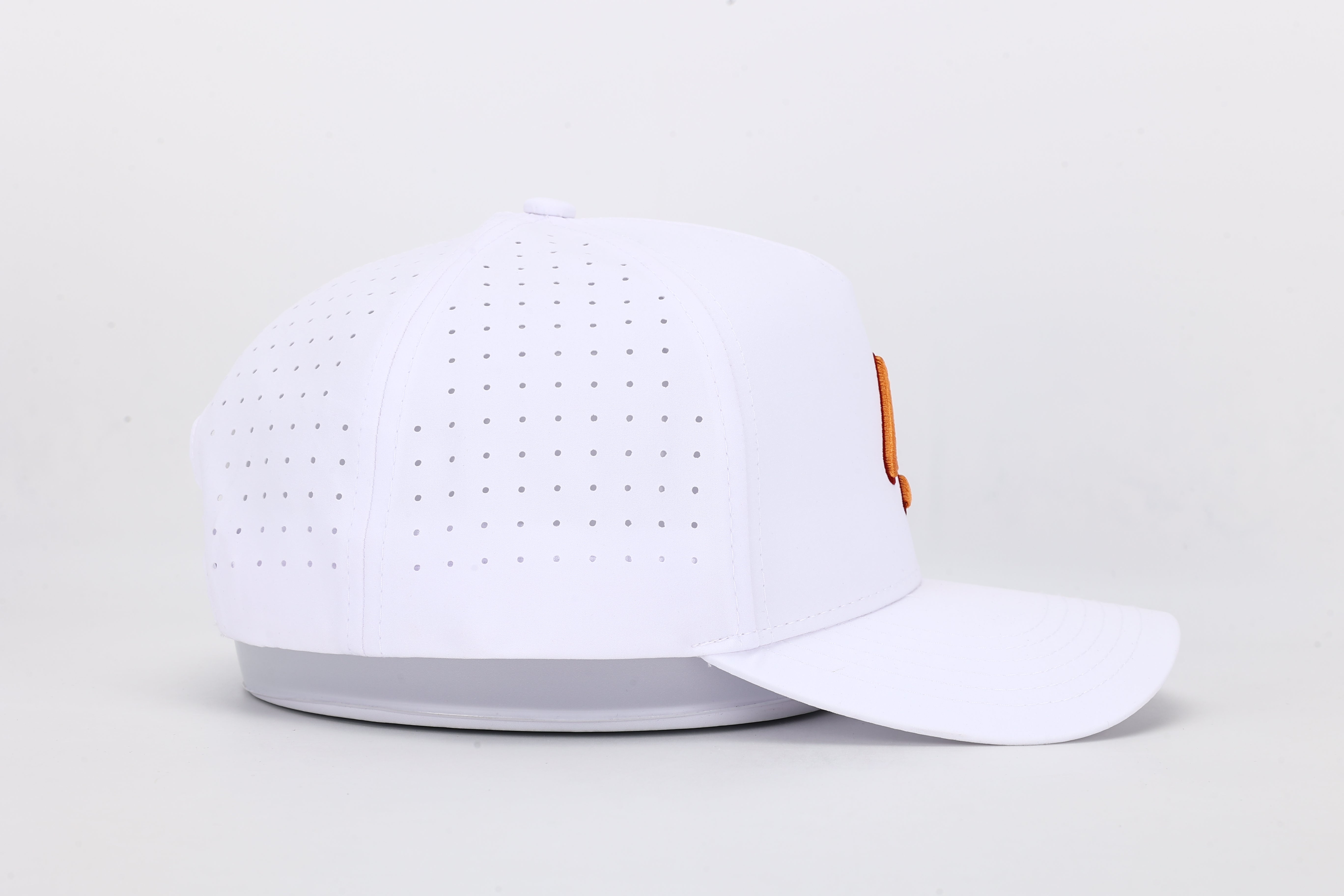 All In Wears Creamsicle cap, a white performance hat with an embroidered orange spade logo for a vibrant, summer look.