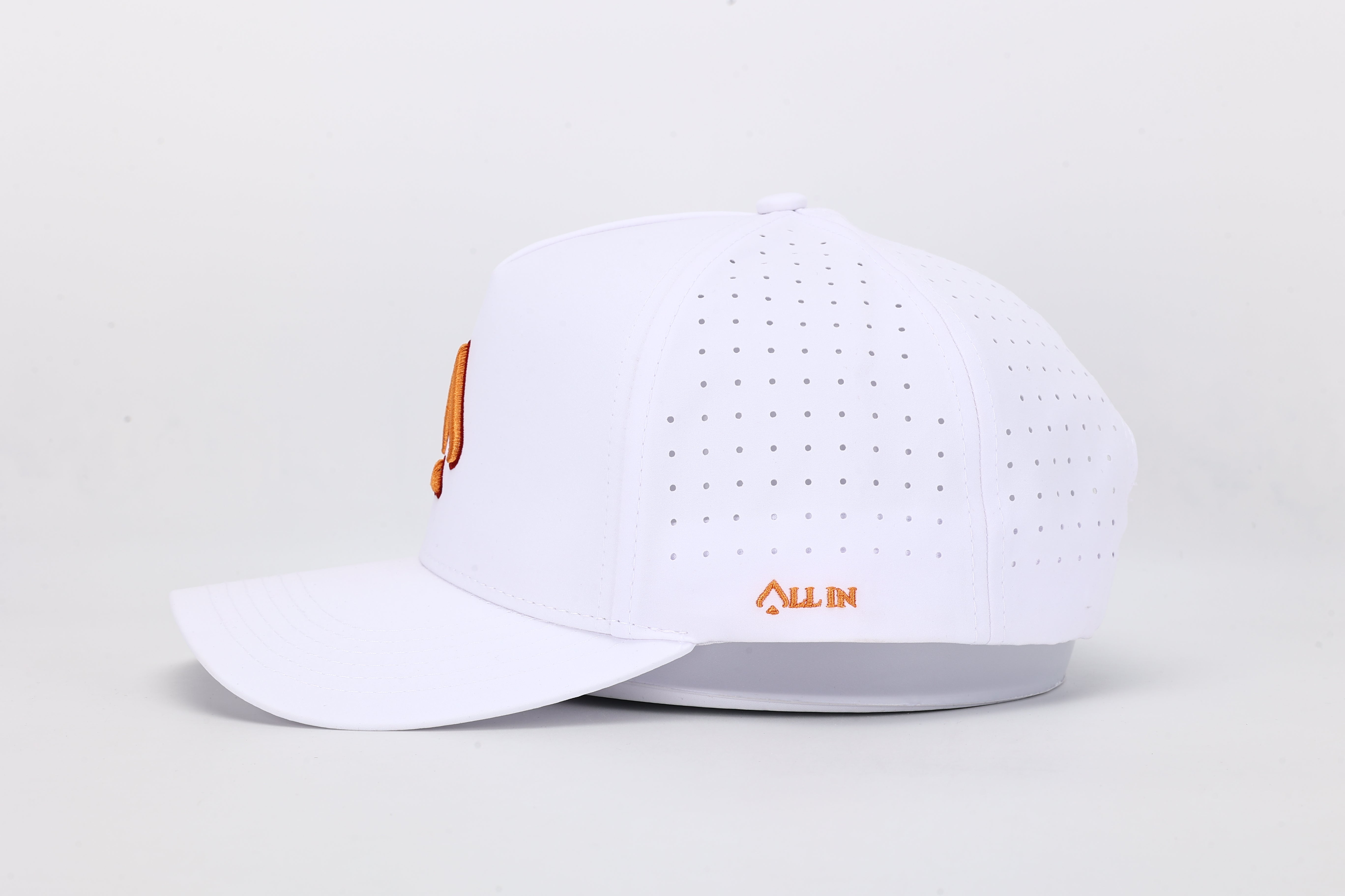 All In Wears Creamsicle cap, a white performance hat with an embroidered orange spade logo for a vibrant, summer look.