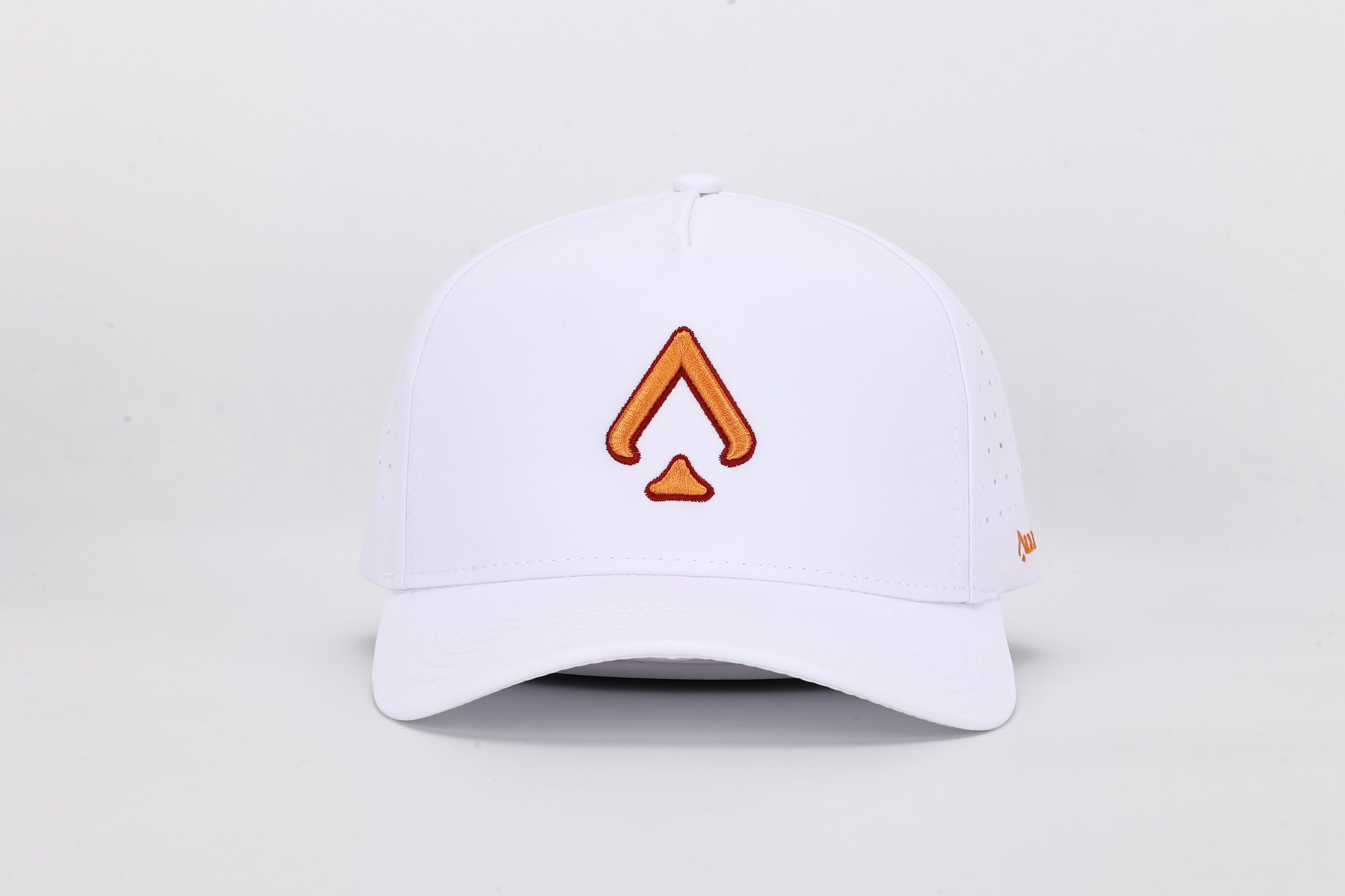 All In Wears Creamsicle cap, a white performance hat with an embroidered orange spade logo for a vibrant, summer look.