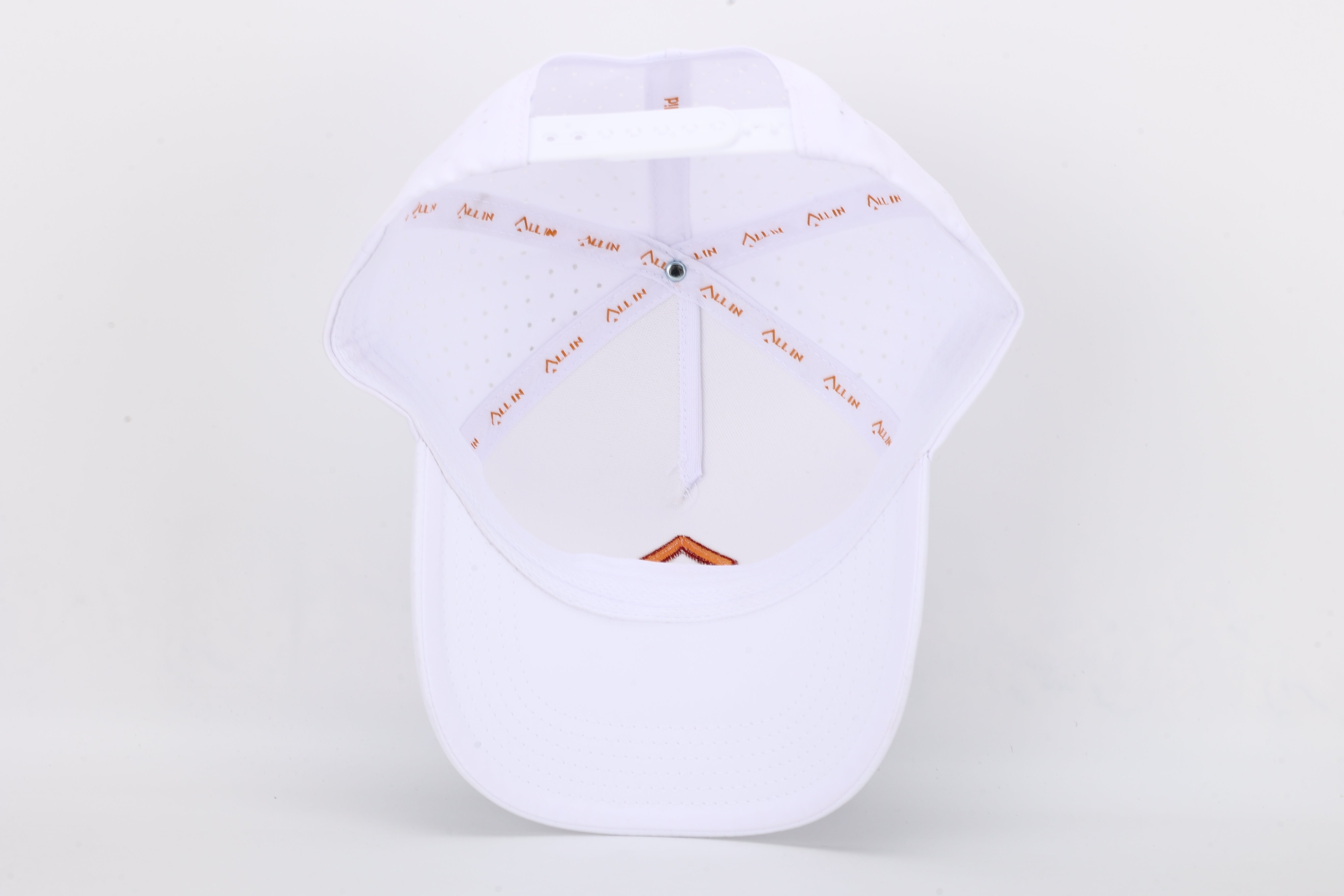All In Wears Creamsicle cap, a white performance hat with an embroidered orange spade logo for a vibrant, summer look.