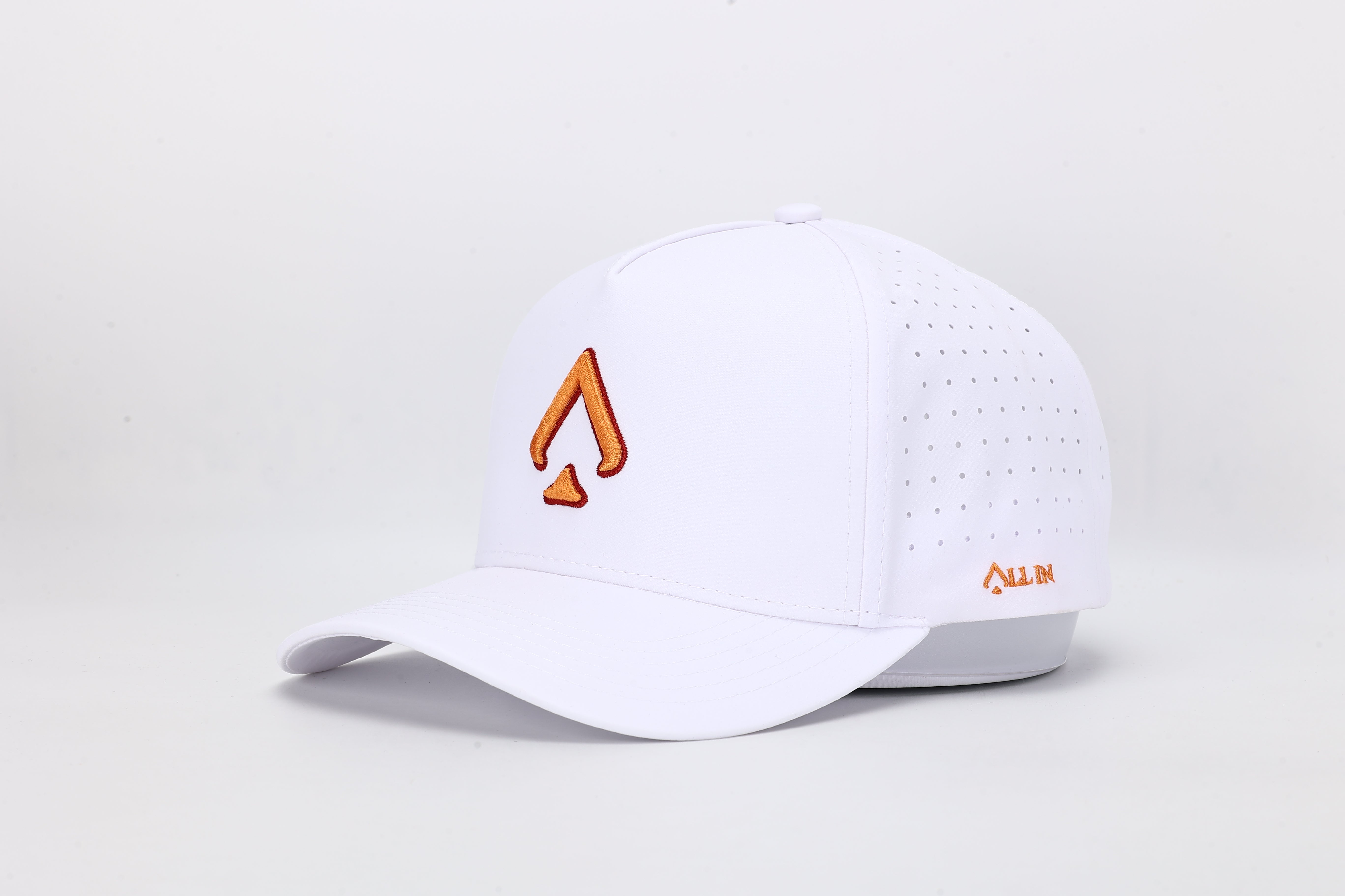 All In Wears Creamsicle cap, a white performance hat with an embroidered orange spade logo for a vibrant, summer look.