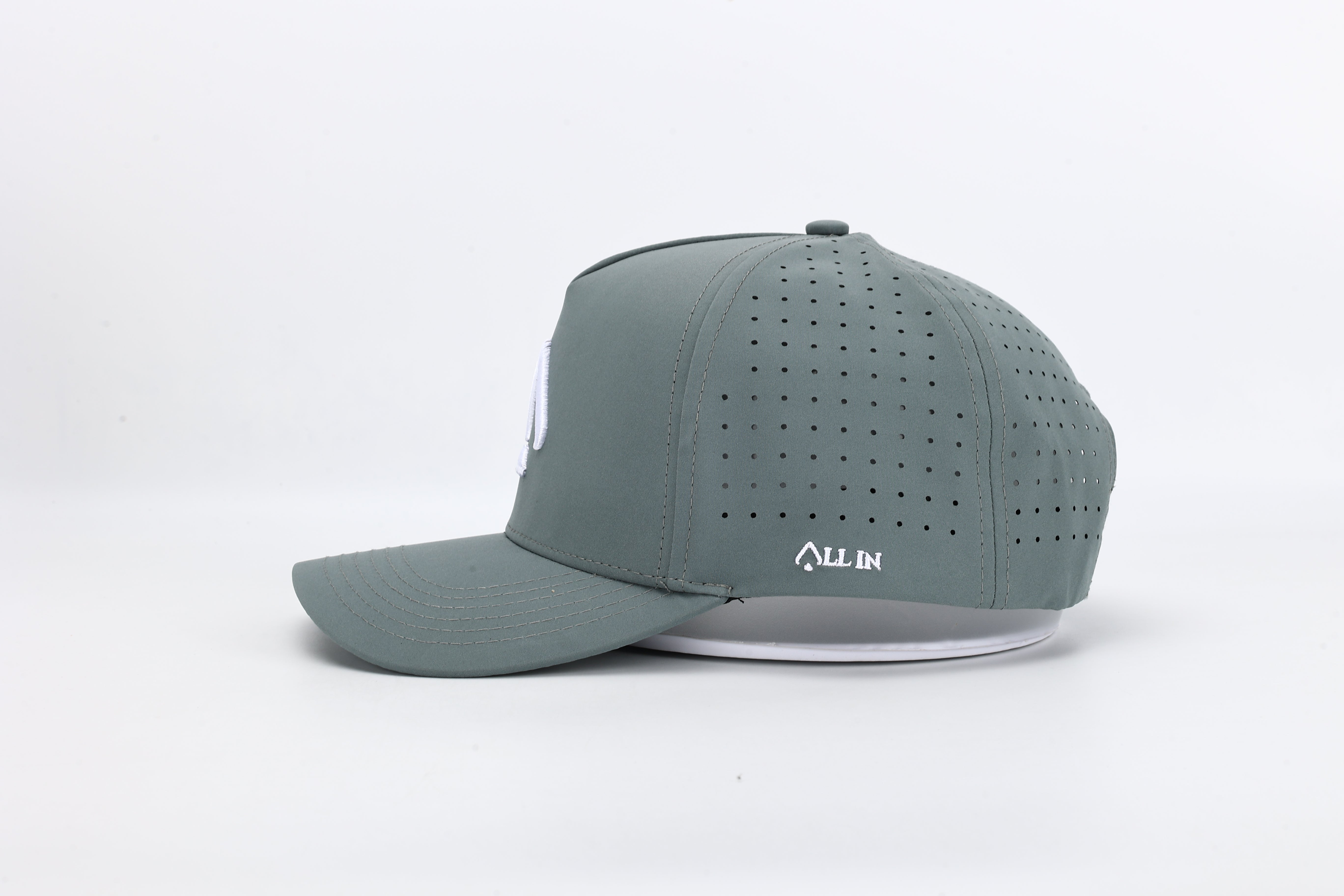 Bloom Gray performance cap featuring the All In logo with laser-cut ventilation holes for breathability and style.